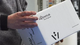 Box of AVENTUS origital parts in the hands of a service technician